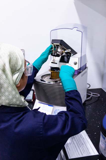 Technician performing additive depletion analysis using lab centrifuge equipment